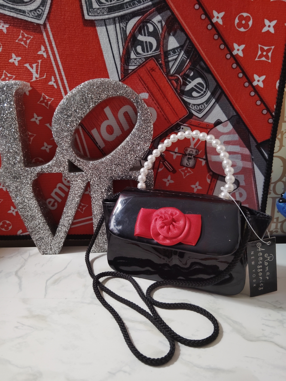 Elegant Black Patent Shoulder Bag with Red Rosette Accent